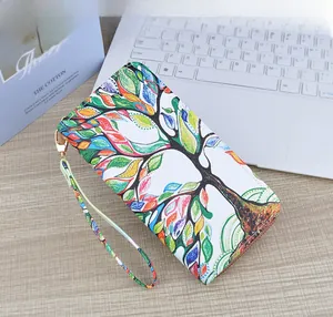 Long zip wallet with colorful tree leaf print and detachable wristlet strap detail