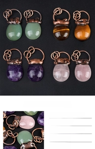 Macro detail of vintage-style stone bag pendants with bronze wire wrapping