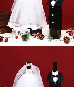 Detailed view of white tulle bridal gown and black suit tuxedo wine bottle covers