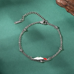 Detailed macro shot of stainless steel double layer bead bracelet with map pendant