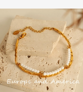 Detailed macro of 18K gold plated double-layer pearl bracelet with lobster clasp