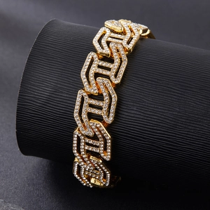 Close-up of golden iced-out Cuban link chain bracelet with clear crystals on display
