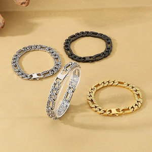 Detail of vintage carved 3:1 NK chain bracelets in gold, black, and antique silver steel