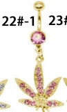 Close-up of golden belly button ring featuring pink crystal and hemp leaf charm pendant
