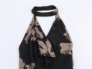 Detail of floral mesh halter neck dress with abstract print and sleek black collar band