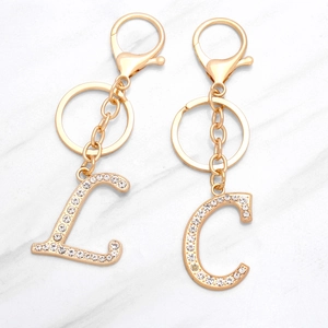 Golden alloy alphabet keychain with sparkling rhinestones letters L and C with clasp