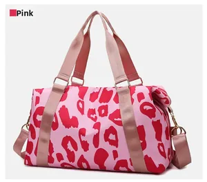 Close-up of pink leopard print travel bag with golden hardware and adjustable strap