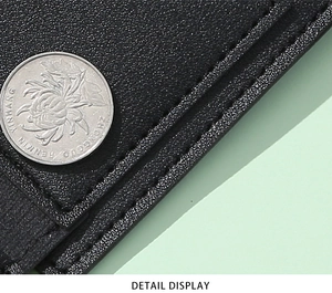 Close-up of black PU leather texture and uniform stitching on minimalist short wallet