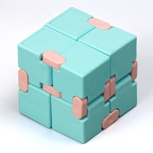 Detailed view of the turquoise infinity cube fidget toy with pink folding hinges