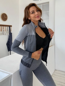 Detail of gray patchwork sports jacket with high collar zipper and elastic fabric