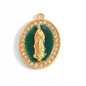 Macro detail of oval gold pendant with Virgin Mary relief and sparkling rhinestones