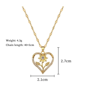 Close-up of golden heart necklace with sunflower detail and clear crystals with dimensions