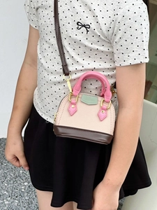 Pink and beige girls shell crossbody bag with adjustable brown strap and handle