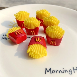 Detailed close-up of mini resin french fries model with iconic red and yellow design
