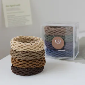 Close-up of high-elastic honeycomb mesh hair ties in earth-toned neutral colors