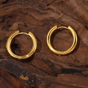 Polished 18k gold plated stainless steel hoop earrings on natural wood background