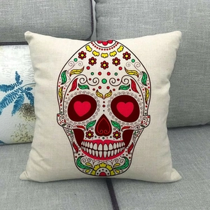 Bohemian colorful sugar skull linen pillow cover with floral patterns on a sofa