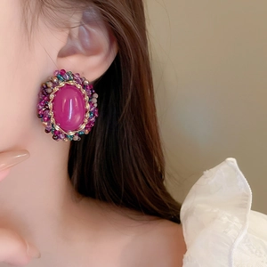 Detail of vintage French court style earrings with purple oval stone and colorful beads