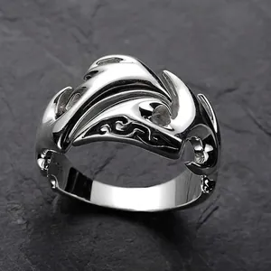 Macro shot of silver ring with 3D cloud pattern on dark stone background