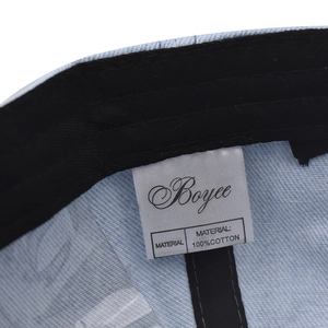 Detail view of cotton baseball cap interior showing sweatband and 100% cotton label