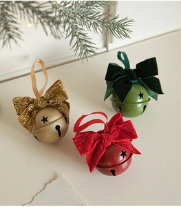 Close-up of velvet bow Christmas bells with star cutouts for festive decoration