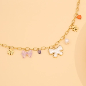 Detail of gold chain necklace with colorful butterfly, flower and heart charms