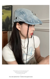 Detail of light blue denim beret featuring a rhinestone bow and vintage washed texture