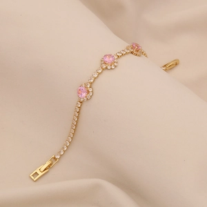 Elegant gold plated bracelet with sparkling zircon stones and pink flower clusters