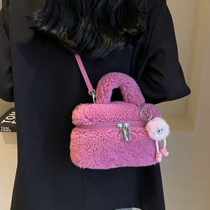 Chic magenta faux fur handbag with plush handle, crossbody strap and monster charm
