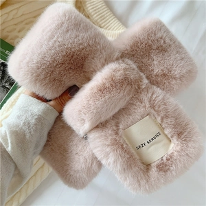 Detail of pink faux rabbit fur scarf showing thick texture and SEZF label