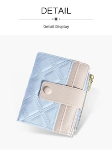 Detail of light blue and beige leather wallet featuring elegant diamond quilting and metal zipper