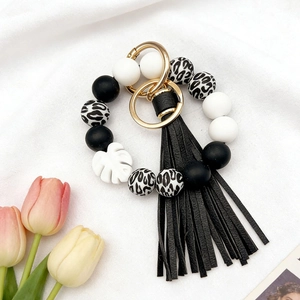 Macro shot of black and white leopard print silicone bead keychain with tulip decor