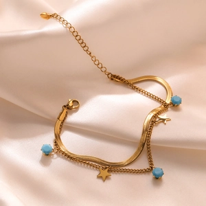 Double-layered gold titanium steel bracelet with blue beads and star charms on satin
