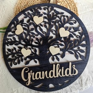 Close-up of wooden Tree of Life plaque with heart-shaped pieces and Grandkids text