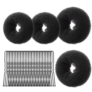 Macro view of assorted black mesh bun makers and metal U-shaped hair pins tools