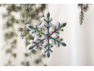 Detail of snowflake-shaped resin ornament with multicolored beads and silver hanging cord