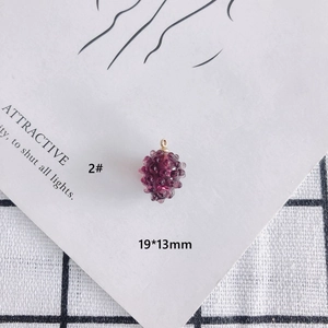 Macro detail of dark purple grape pendant with golden loop and 19x13mm size info