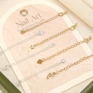 Detailed view of 18k gold extension chains with lobster clasps and star heart charms