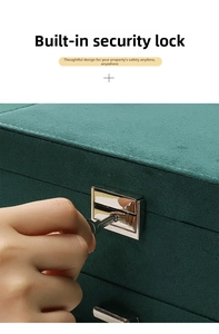 Detailed view of emerald green velvet jewelry box with secure silver metal lock and key
