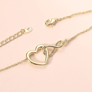 Golden infinity heart bracelet with small zircon on minimalist fine chain and lobster clasp