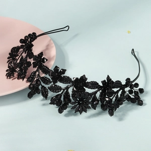Close-up of black floral gothic headband with dark crystal and beaded metal details