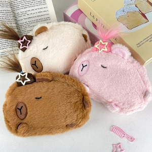 Detailed view of Capybara plush pouches in white, pink, and brown with soft fur texture