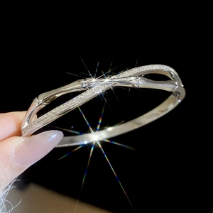 Close-up of 18k silver-plated bamboo-style crossover bangle with pavé-set cubic zirconia