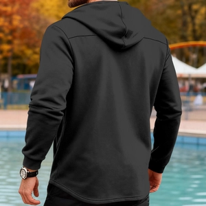 Slim fit men's hooded windbreaker in solid black, outdoor back view perspective