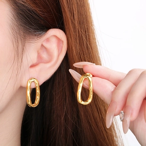 Irregular golden teardrop earrings with artistic lava texture for a minimalist style