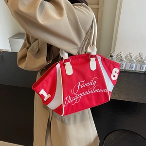 Red canvas bowling bag with white handles and embroidery shown in a modern interior setting