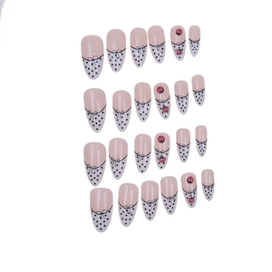 Detail of 24 almond press-on nails with french polka dots, bows and ladybug patterns