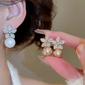 Elegant floral zircon and pearl drop earrings in white and champagne gold finishes