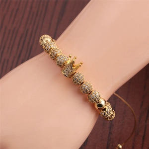 Adjustable golden crown beaded bracelet with Roman numerals on model wrist
