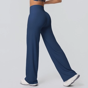 Side view of dark blue high-waisted flared yoga pants with elastic slimming effect
